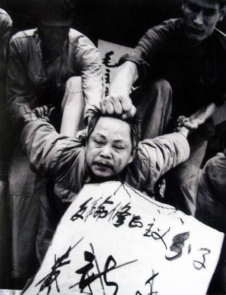 HONG KONG, CHINA: An undated picture from the documentary film "Morning Sun" shows Huang Xinting, the commander of the Chengdu Military Region, being struggled against at his headquarters in 1967, the victim being forced to bow forward while his arms are twisted and bent back at an impossible angle--called "doing the jet plane". The film by Carma Hinton, 53, the China-born daughter of an American Maoist and co-directed with her husband Richard Gordon and Australian academic Geremie Barme, show the early decades of communist rule. AFP PHOTO (Photo credit should read -/AFP/Getty Images)